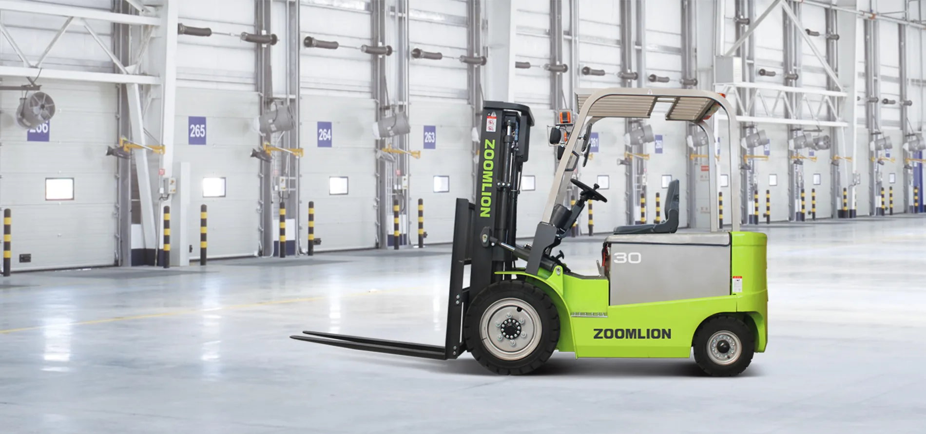 Green electric forklift in an industrial warehouse